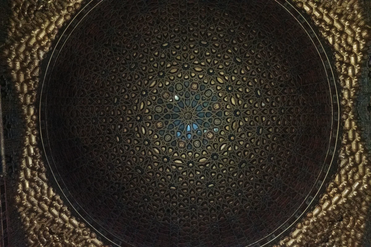 Dark gilded Mudejar dome with a radiating star pattern