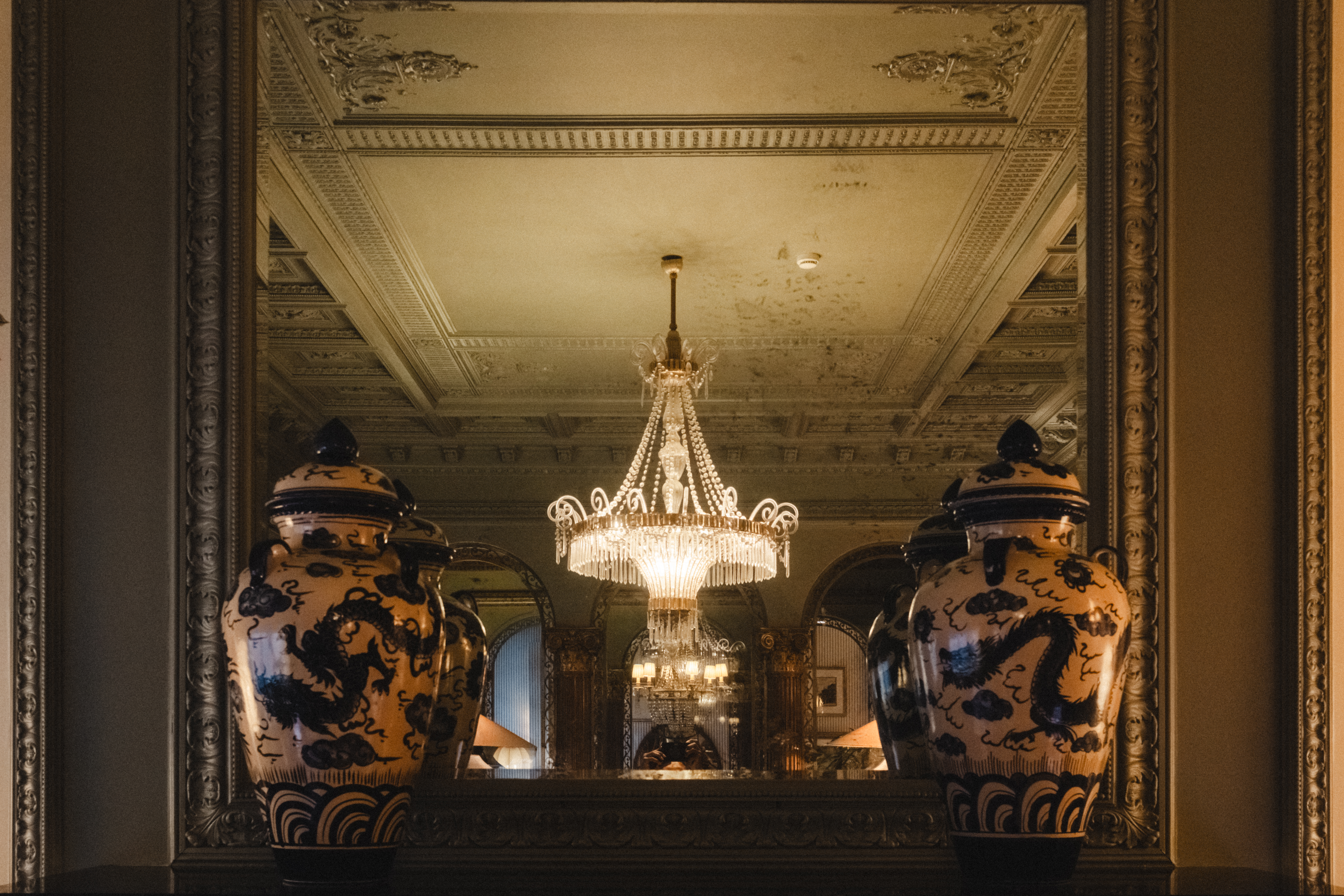 Vases and chandelier reflections
