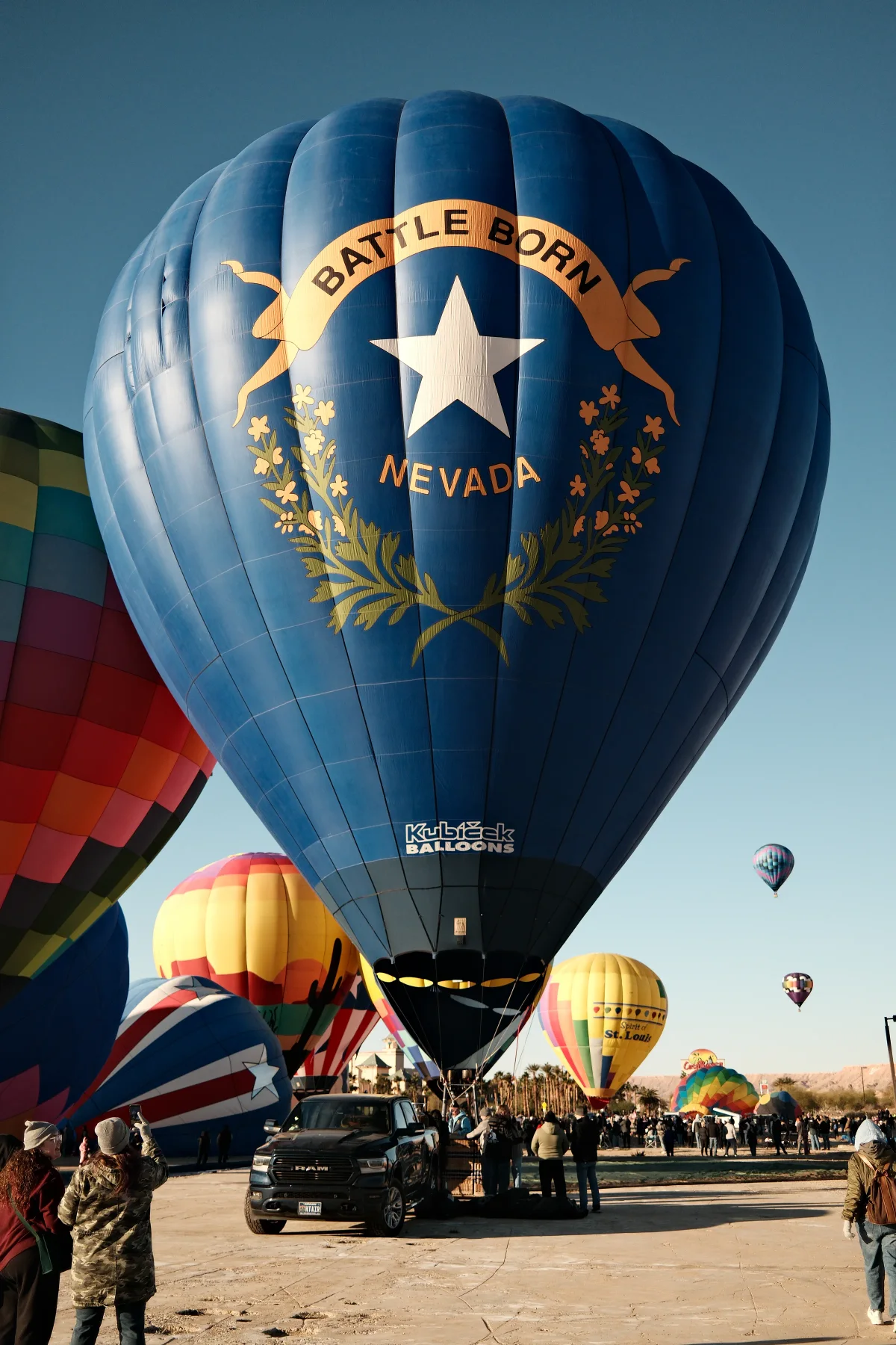 Blue Battle Born Nevada hot air balloon towering over the crowd in Mesquite, Nevada