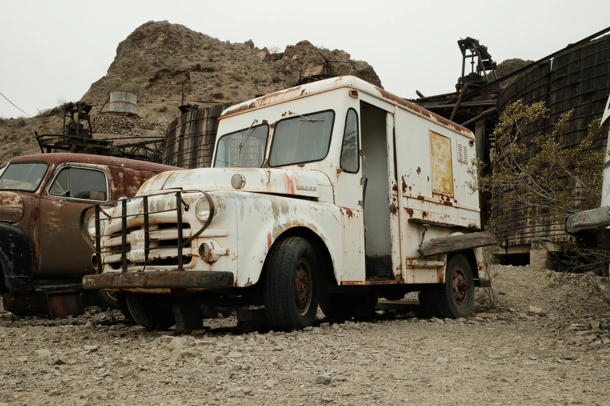 Rusted white vintage delivery truck among old mine structures at Nelson Ghost Town, Eldorado Canyon, Nevada