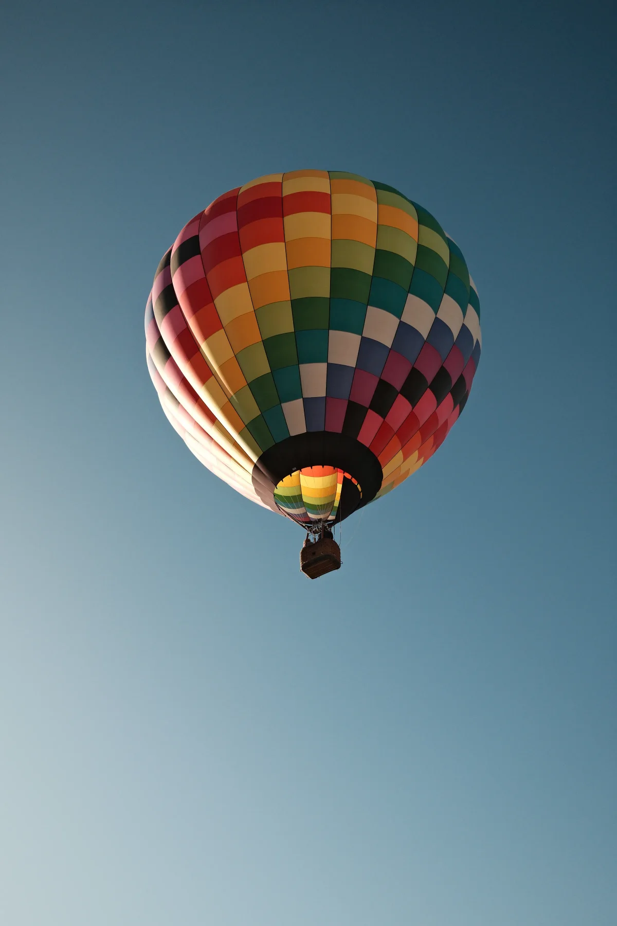 Brightly checkered hot air balloon floating overhead at the Mesquite, Nevada balloon festival