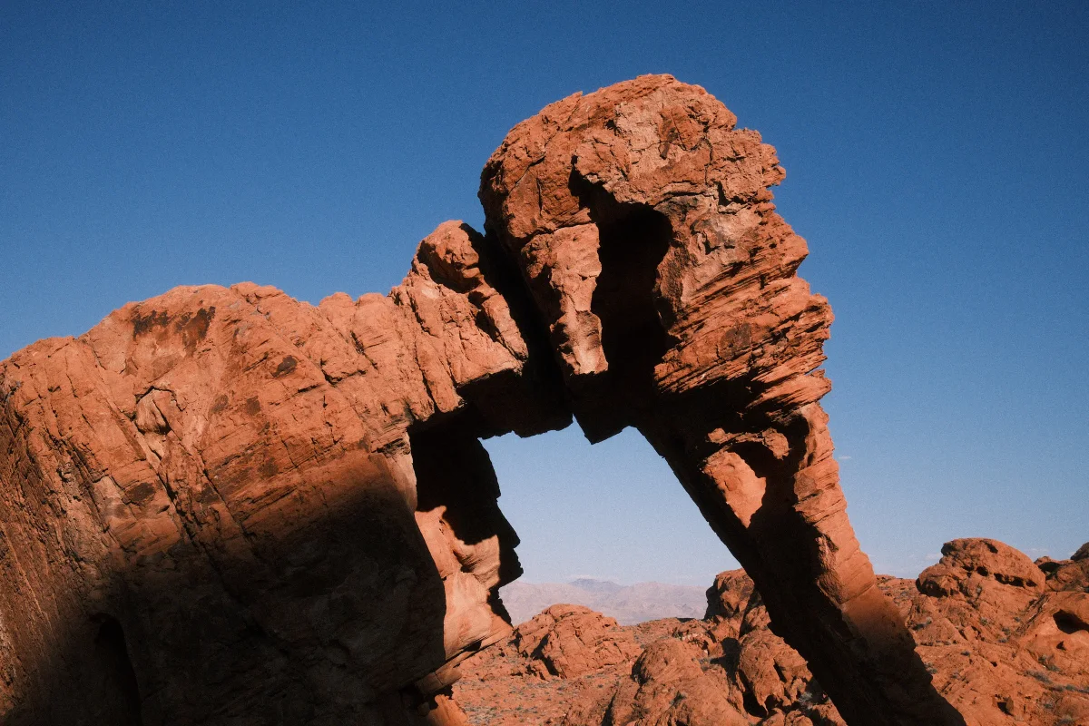 Red sandstone Elephant Rock arch against a deep blue sky in Valley of Fire